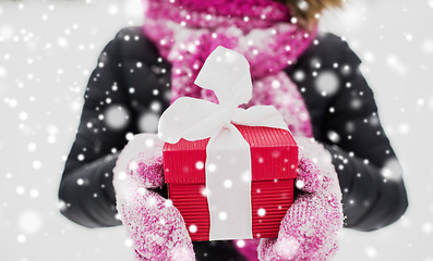 Image showing close up of woman with christmas gift outdoors