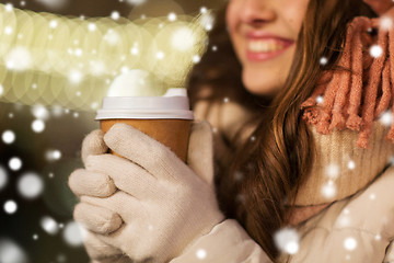 Image showing happy woman with coffee over christmas lights