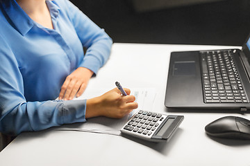 Image showing businesswoman with papers working at night office