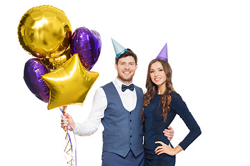 Image showing happy couple with party caps and balloons