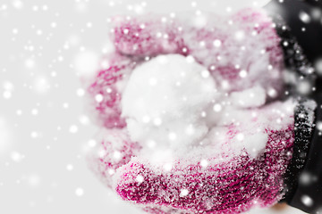 Image showing close up of woman holding snowball outdoors