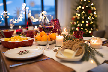 Image showing glass of red wine and food on christmas table