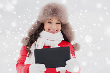 Image showing woman in winter fur hat with tablet pc outdoors