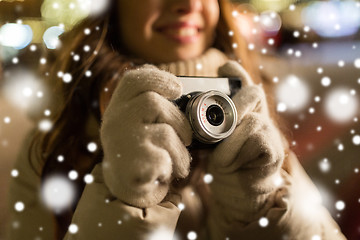 Image showing close up of happy woman with camera at christmas