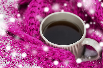 Image showing close up of tea or coffee and winter scarf in snow