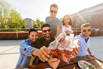 Image showing happy friends toasting drinks at rooftop party