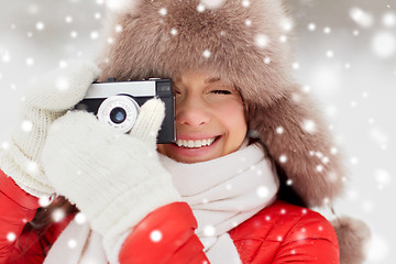 Image showing happy woman with film camera outdoors in winter