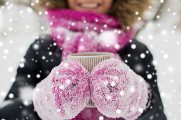 Image showing close up of woman with tea mug outdoors in winter