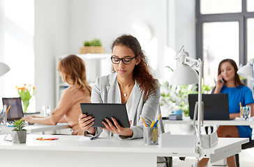 Image showing businesswoman with tablet pc working at office