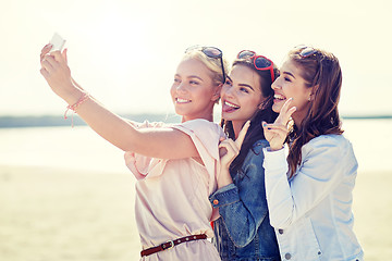 Image showing group of smiling women taking selfie on beach