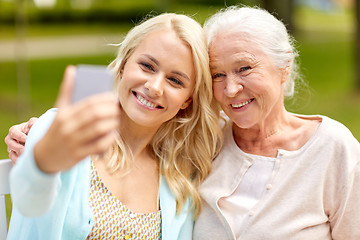 Image showing daughter and senior mother taking selfie at park