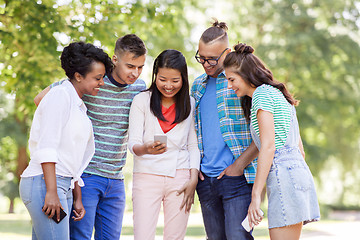 Image showing group of happy friends with smartphone outdoors