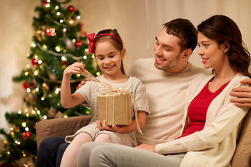 Image showing happy family with christmas present at home