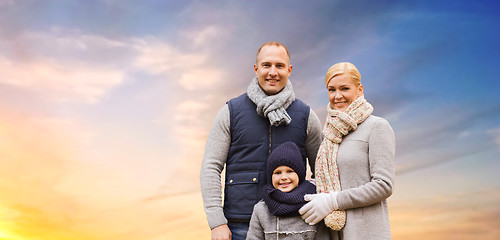 Image showing happy family over evening sky background