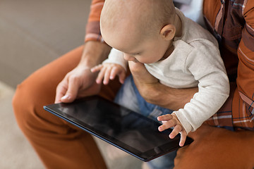 Image showing close up of father and baby son with tablet pc