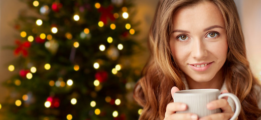 Image showing close up of woman with coffee cup on christmas