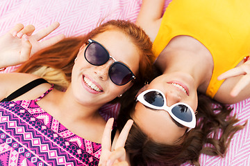 Image showing teenage girls in sunglasses showing peace sign