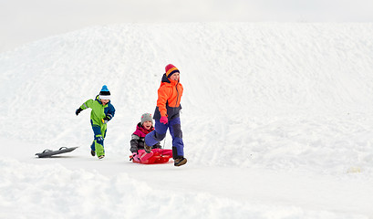 Image showing happy kids with sled having fun outdoors in winter