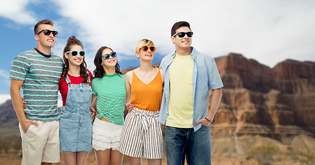 Image showing friends in sunglasses over grand canyon