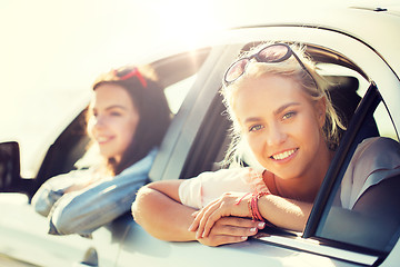 Image showing happy teenage girls or women in car at seaside