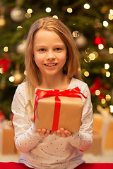 Image showing smiling girl with christmas gift at home