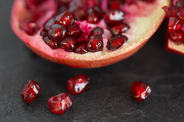 Image showing close up of pomegranate on stone table