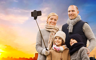 Image showing family taking selfie over sunset in city