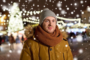 Image showing happy man in winter clothes at christmas market