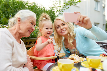 Image showing happy family taking selfie at cafe