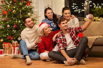 Image showing friends celebrating christmas and taking selfie