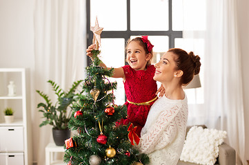 Image showing mother and daughter decorating christmas tree