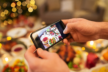 Image showing hands photographing food at christmas dinner