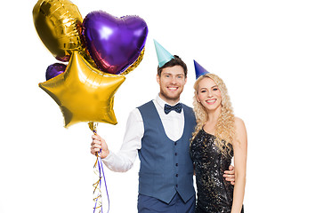 Image showing happy couple with party caps and balloons