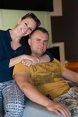 Image showing young handsome couple hugging on the sofa