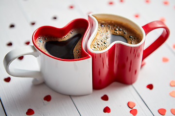 Image showing Two heart shaped coffee cups conected with each other.