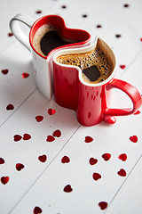 Image showing Two heart shaped coffee cups conected with each other.