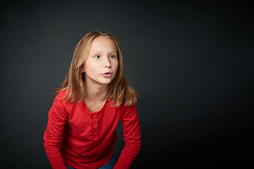 Image showing Happy girl looking with widely opened eyes and toothy smile