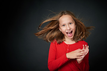 Image showing Excited surprised preteen girl screaming of joy