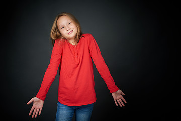 Image showing Little girl shrugging her shoulders