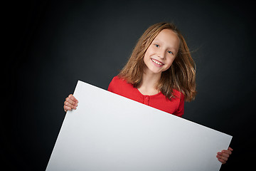 Image showing Happy girl looking with widely opened eyes and toothy smile