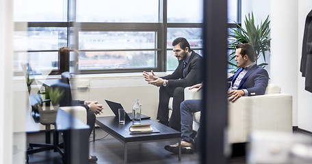 Image showing Business people sitting at working meeting in modern corporate office.