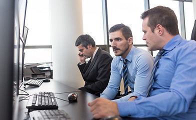 Image showing Worried stock traders brainstorming in corporate office.