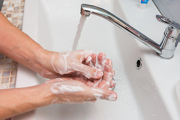 Image showing Washing hands with soap in the sink