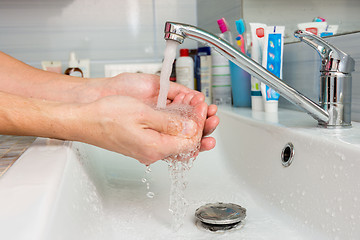 Image showing Hands under the tap from the mixer