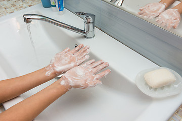 Image showing Child shows soaped hands