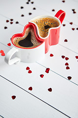 Image showing Two heart shaped coffee cups conected with each other.