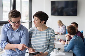 Image showing Two Business People Working With Tablet in office