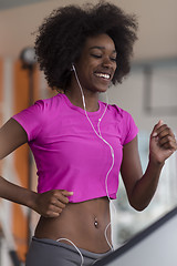 Image showing afro american woman running on a treadmill