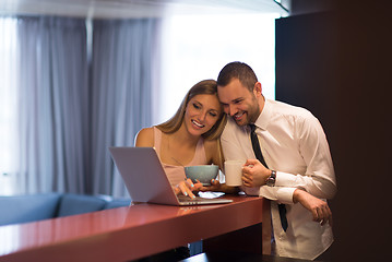 Image showing A young couple is preparing for a job and using a laptop