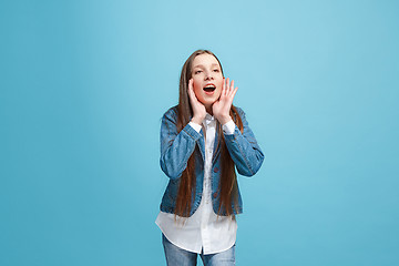 Image showing Isolated on pink young casual teen girl shouting at studio